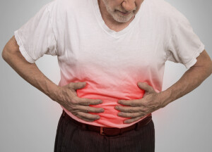 Stomach ache, man placing hands on the abdomen