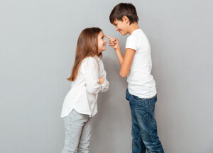 two-happy-children-standing-looking-each-other-scaled